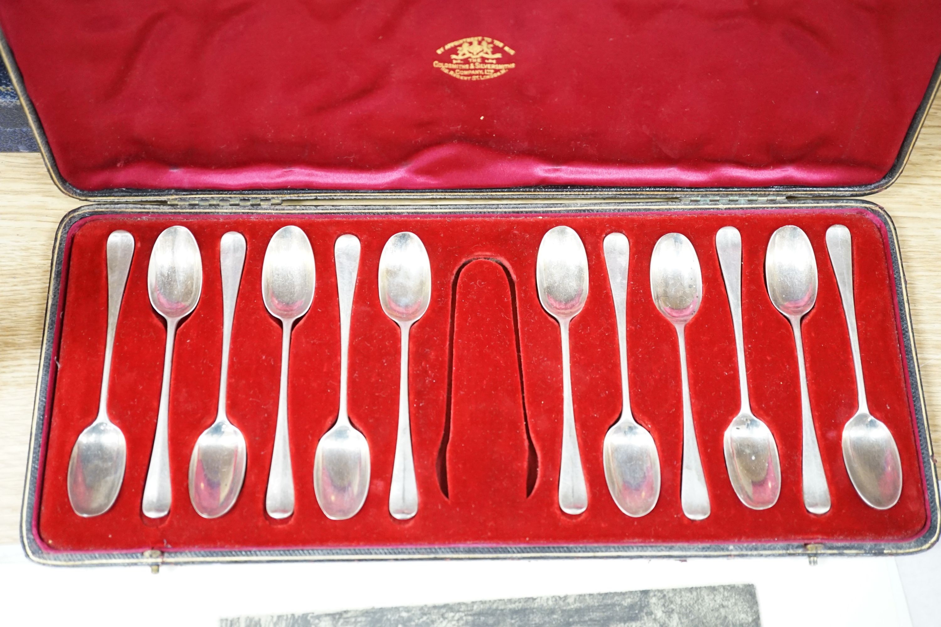 A cased modern silver three piece condiment set, a cased set of twelve Edwardian silver teaspoons, London, 1903 (lacking tongs) and two plated fish services.
